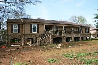 Completed elevated home permanently set on its new stone foundation