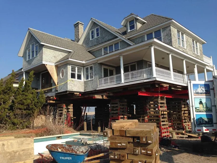 Expert House Movers crew elevating a coastal Texas home on hydraulic jacks