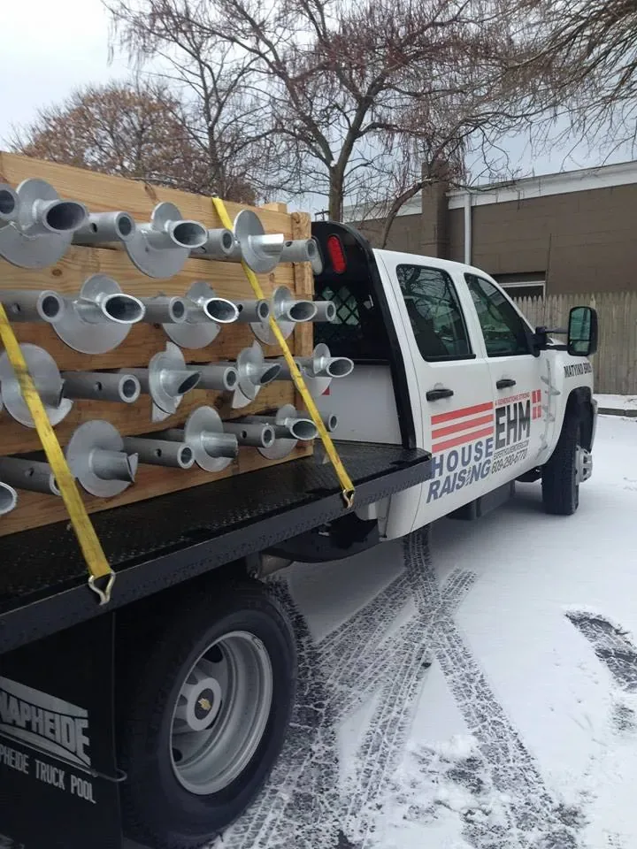 Galvanized helical piers loaded on an EHM House Raising truck
