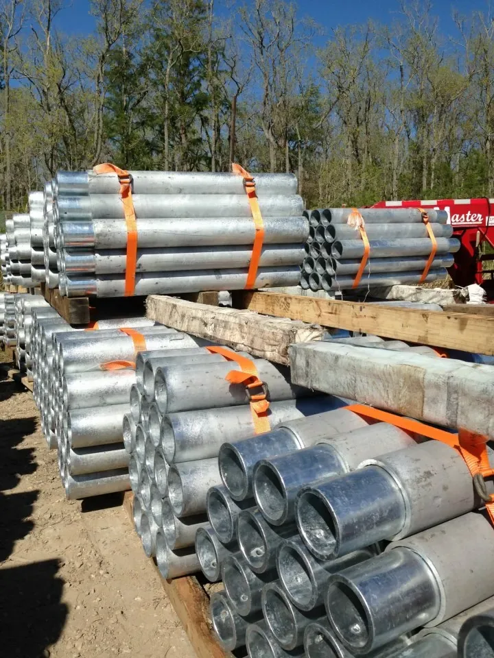 Bundles of galvanized steel push-pier sections staged for a foundation leveling job